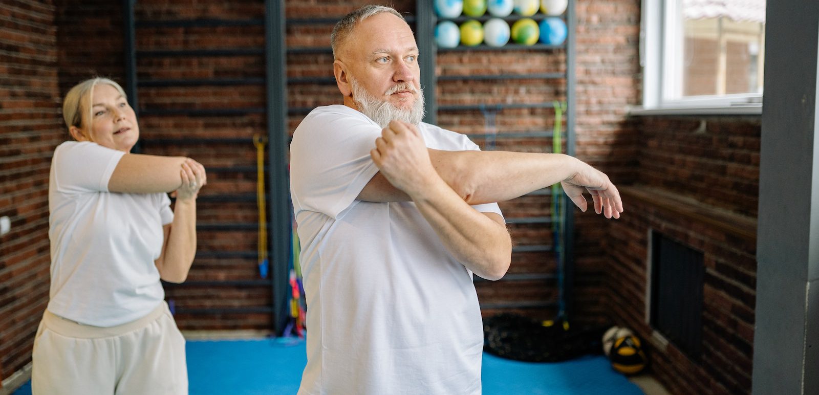 An Elderly Couple Doing Arms Stretching Exercise